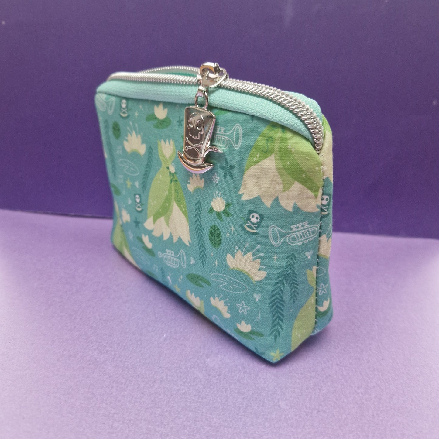 Down the Bayou mini triangle shaped pouch cosmetic bag with shadowman zipper pull
