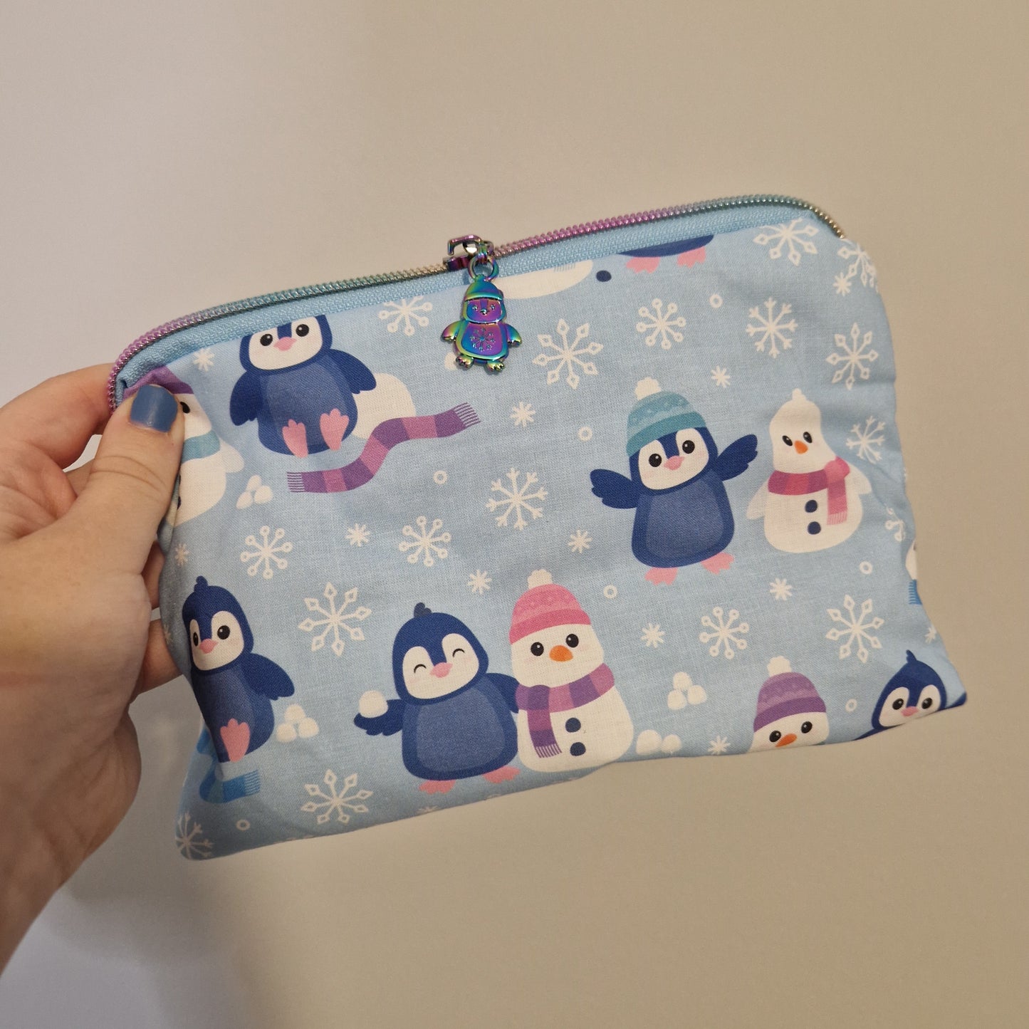 Cosy penguin lined triangle cosmetic bag with matching zipper pull
