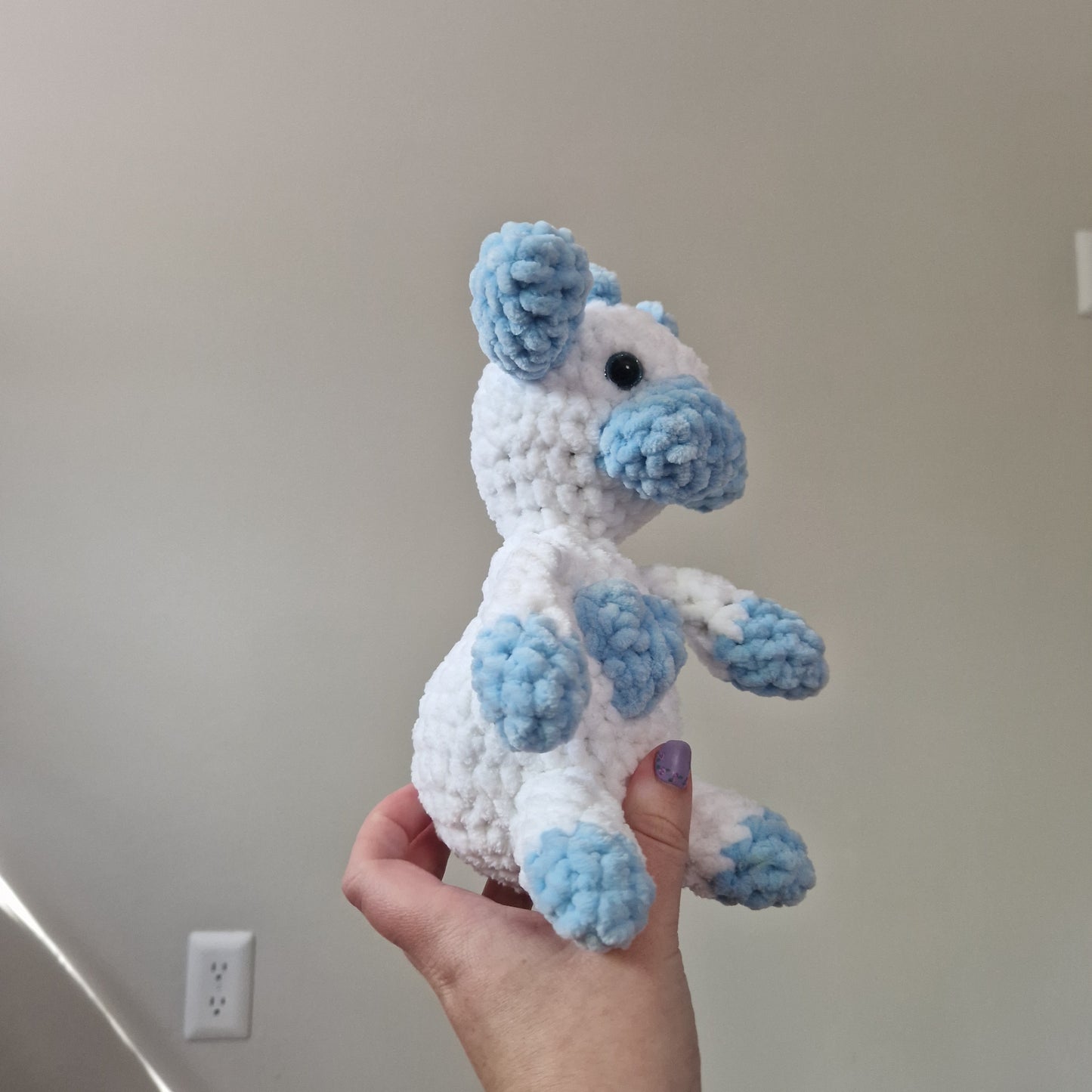 Blue and white sitting cow crochet plushie