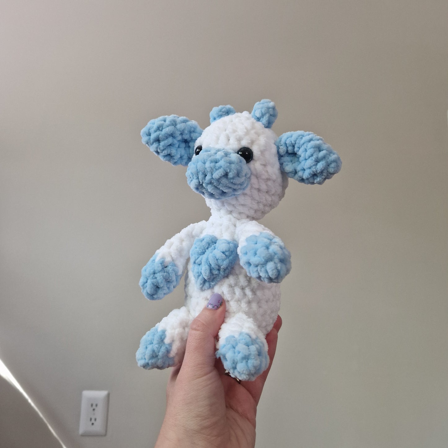 Blue and white sitting cow crochet plushie