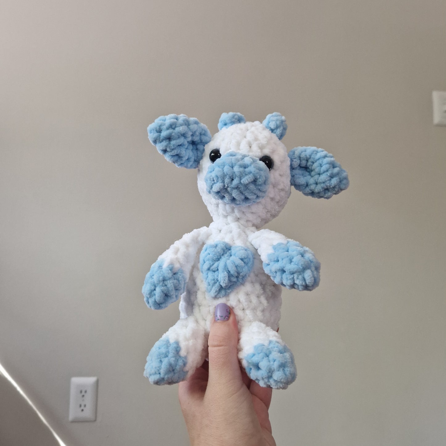 Blue and white sitting cow crochet plushie