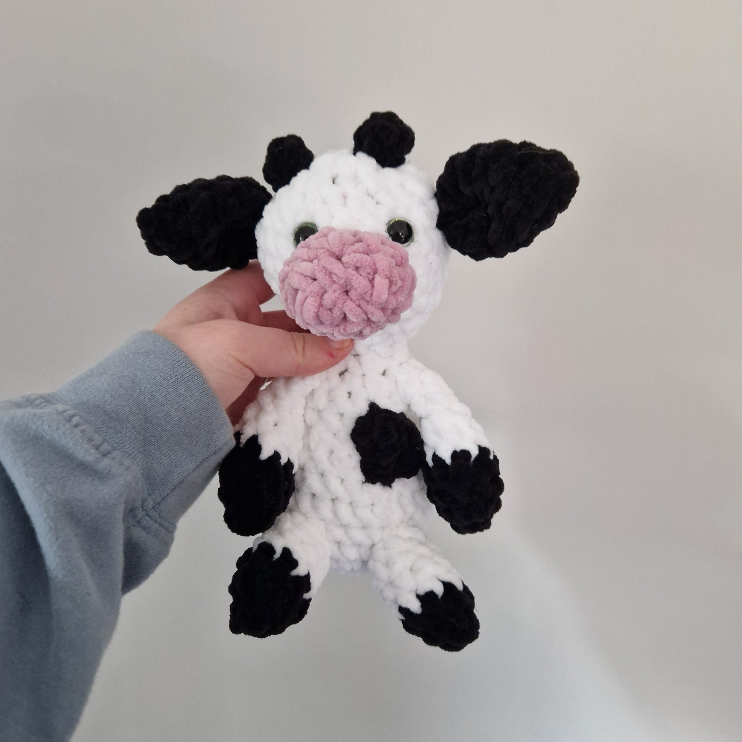 Black and white sitting cow crochet plushie